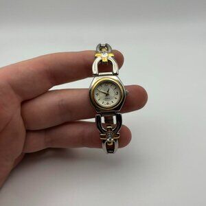 Vintage white face women’s watch with gold tone. Silver stretchy band!